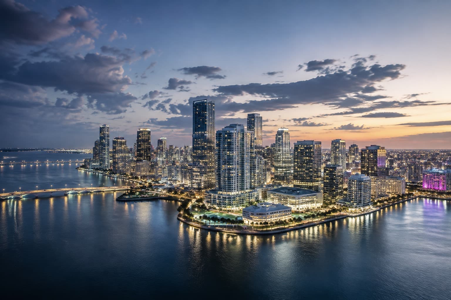 The Miami skyline lit at dusk, seen across Biscayne Bay